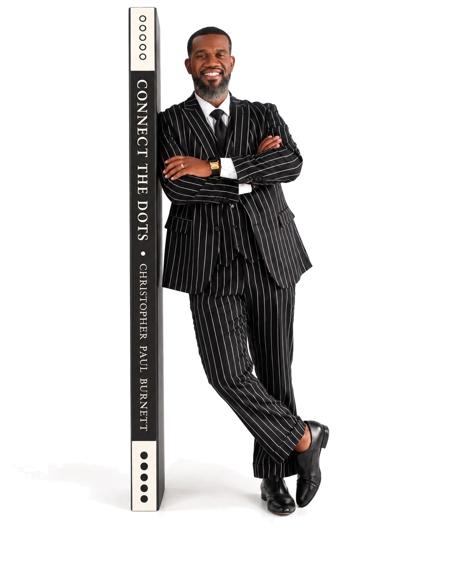 Christopher Paul Burnett standing beside the spine of Connect the Dots