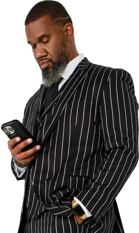 Christopher Paul Burnett in a pinstripe suit, checking his phone